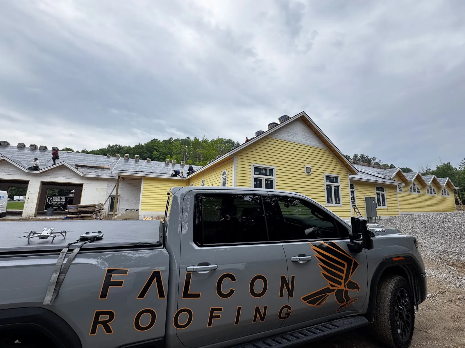A Falcon Roofing truck at a local job site, not a national call center.