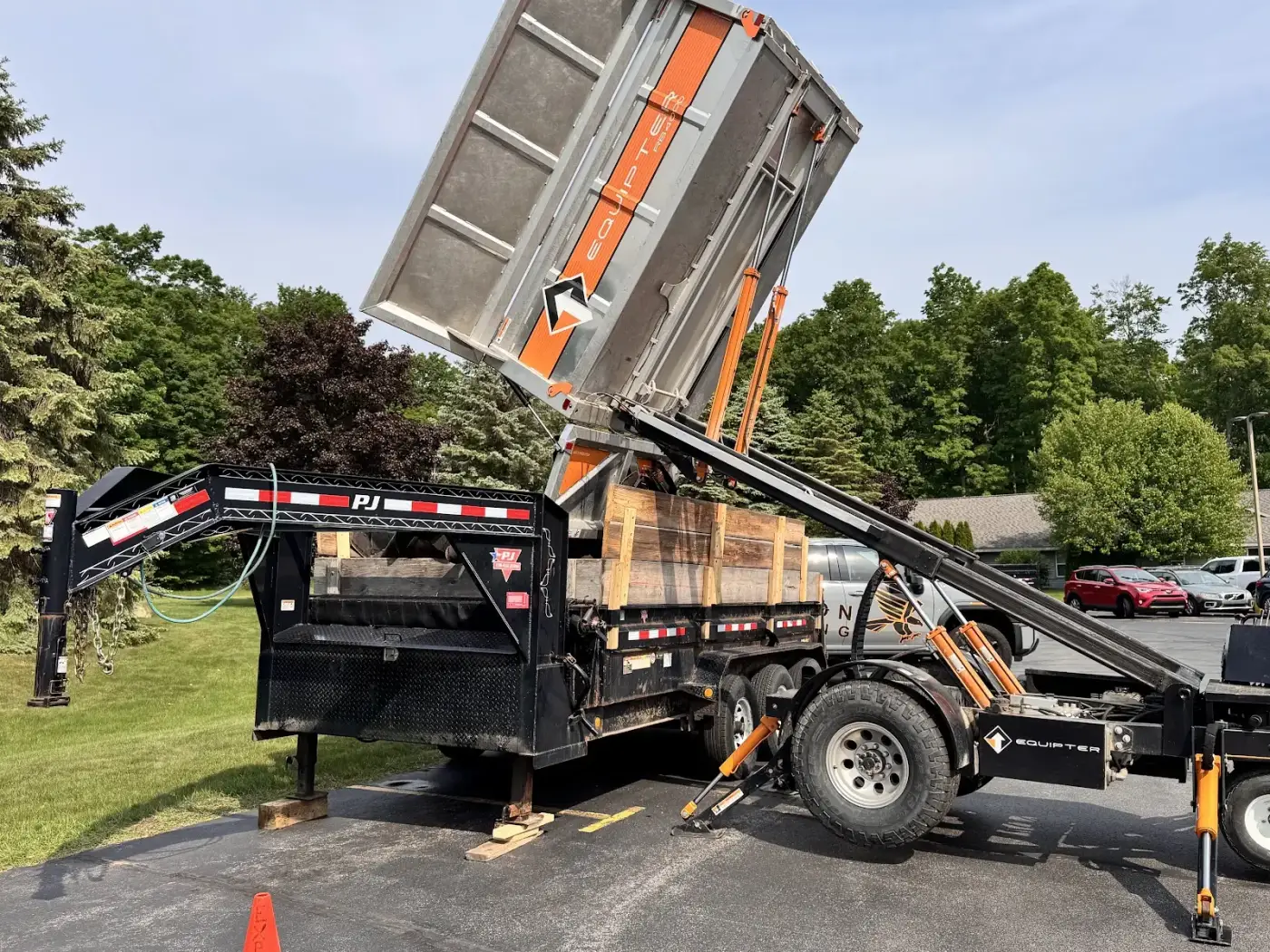 A dump trailer staged on site keeps a tear-off moving on schedule.