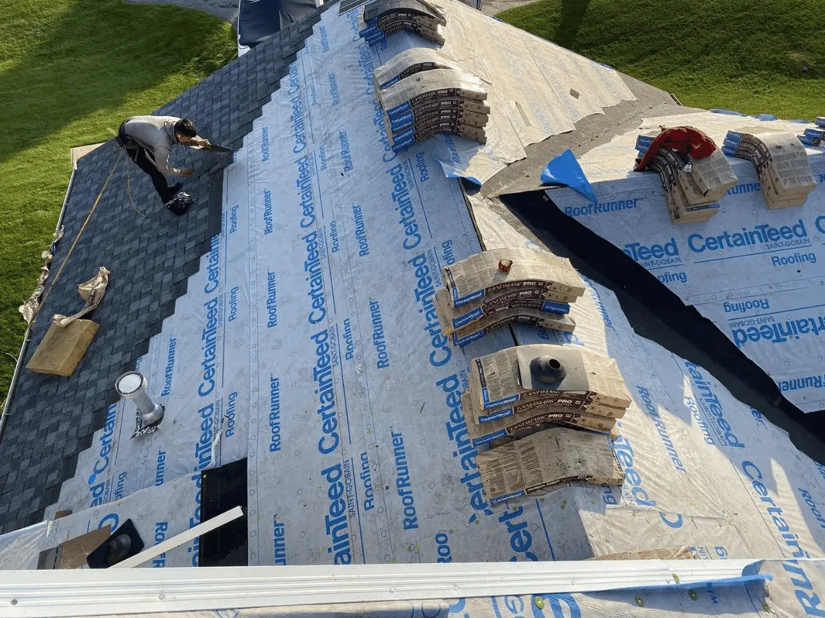 A quality shingle installation in progress, with underlayment and staged materials