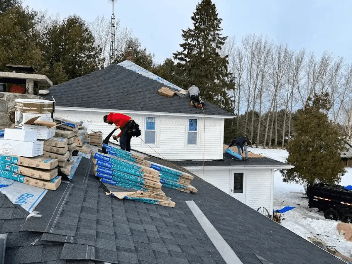 A Falcon Roofing crew installing a new roof on a Traverse City home