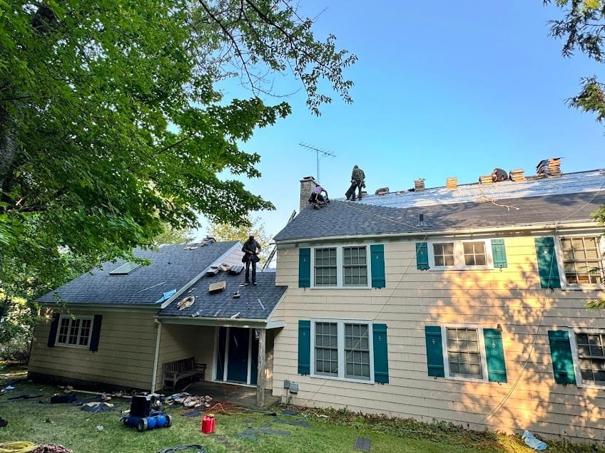 Falcon Roofing crew working on a residential roof in Traverse City